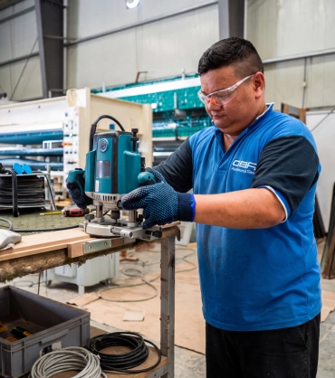 Technician fabricating aluminium components at an Aluminium & Glass Company in Dubai