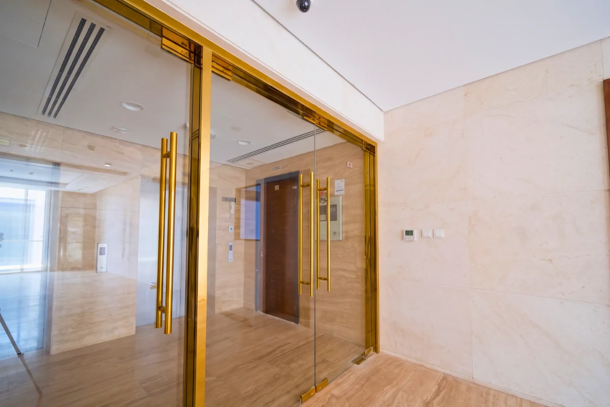 Frameless glass doors in a modern interior entrance.