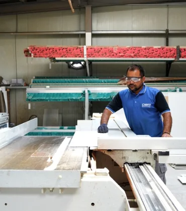 OBA Aluminium & Glass Contracting team member fabricating aluminium profiles at the workshop in Dubai.